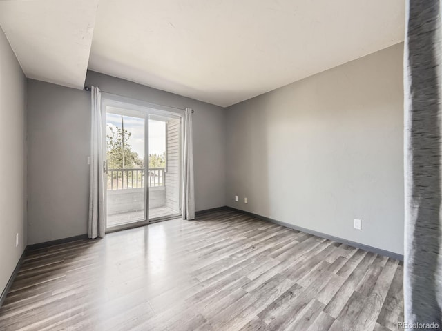 unfurnished room featuring wood finished floors and baseboards