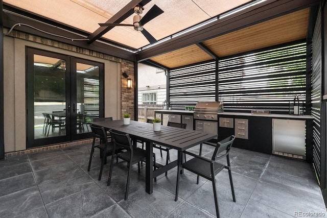 view of patio with an outdoor kitchen, outdoor dining space, a grill, ceiling fan, and french doors