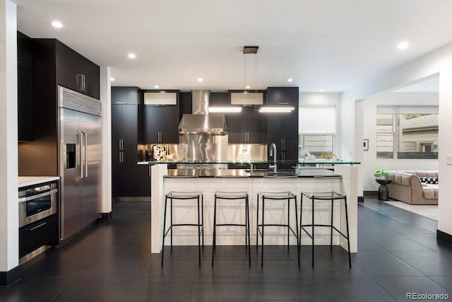 1927 S Grant St, Denver, CO 80210 - kitchen with stainless steel appliances, wall chimney range hood, modern cabinets, tasteful backsplash, and dark cabinets