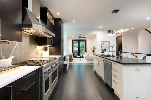1927 S Grant St, Denver, CO 80210 - kitchen featuring stainless steel appliances, wall chimney range hood, modern cabinets, dark cabinetry, and recessed lighting