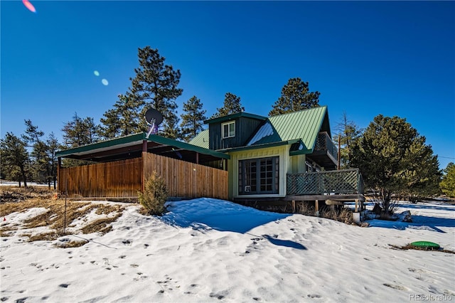 view of snowy exterior featuring metal roof