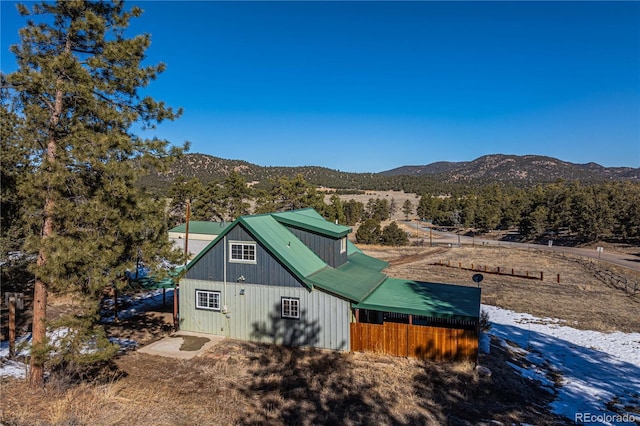 exterior space with a mountain view and fence