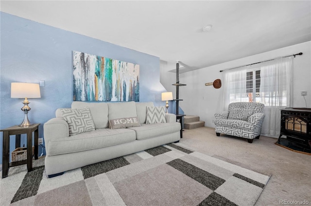 living area featuring carpet floors and a wood stove