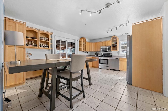 dining area with light tile patterned floors and a textured ceiling
