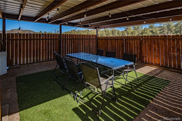 view of patio with outdoor dining space and a fenced backyard