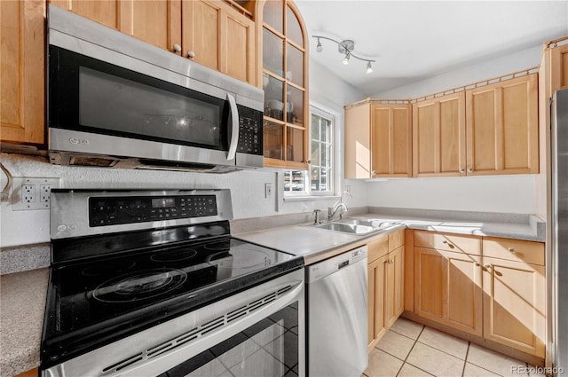 kitchen featuring a sink, appliances with stainless steel finishes, and light brown cabinetry