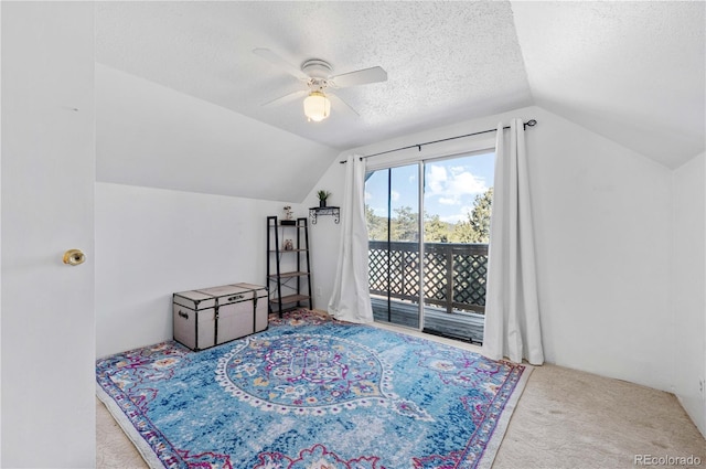 bonus room featuring a ceiling fan, a textured ceiling, carpet flooring, and vaulted ceiling