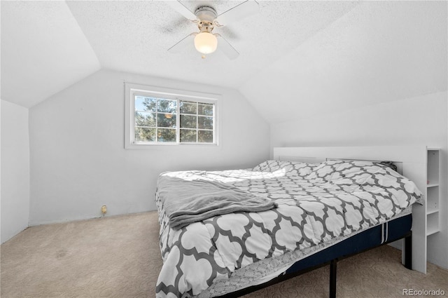 bedroom featuring ceiling fan, a textured ceiling, lofted ceiling, and carpet floors