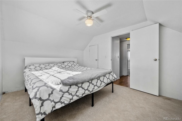 bedroom with carpet floors, a ceiling fan, and vaulted ceiling