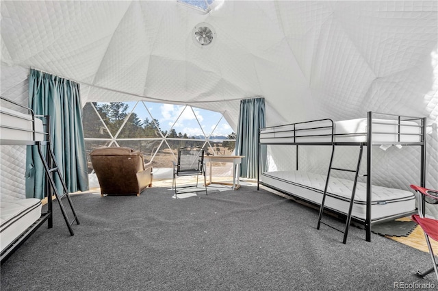 unfurnished bedroom featuring high vaulted ceiling and carpet floors