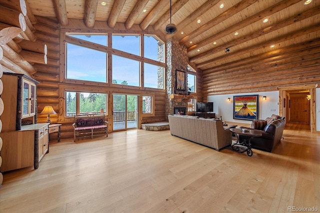living area with a fireplace, light wood-style flooring, wood ceiling, high vaulted ceiling, and beamed ceiling