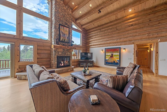 living area with wood ceiling, light wood-style flooring, beam ceiling, and a stone fireplace
