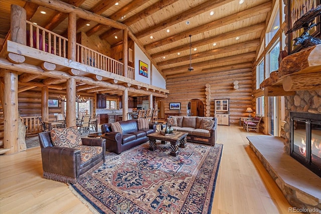 living room with a fireplace, rustic walls, wood-type flooring, wood ceiling, and high vaulted ceiling