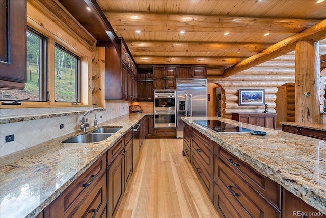 kitchen with tasteful backsplash, light wood-style flooring, appliances with stainless steel finishes, beamed ceiling, and a sink