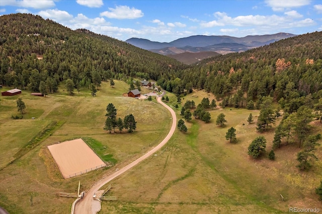 birds eye view of property featuring a mountain view and a forest view
