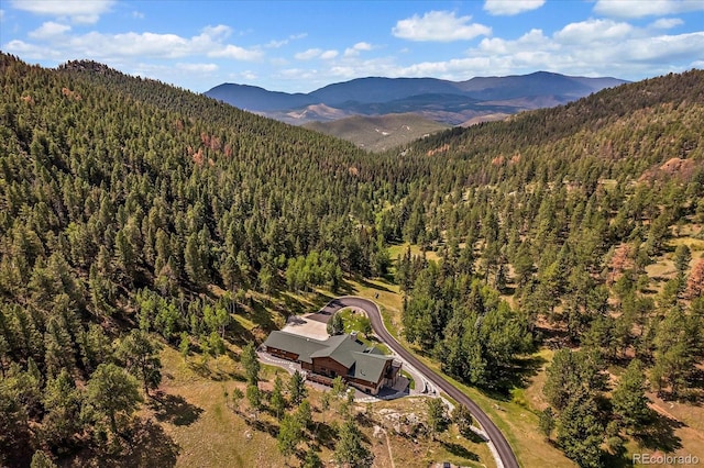 bird's eye view with a mountain view and a view of trees