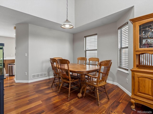 dining area with dark wood-type flooring