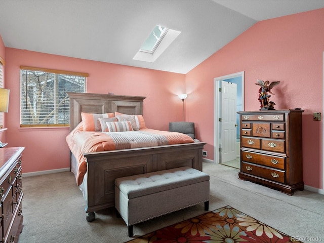 carpeted bedroom featuring lofted ceiling with skylight