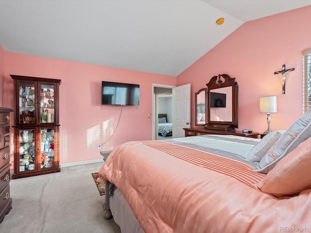 bedroom with lofted ceiling and light carpet