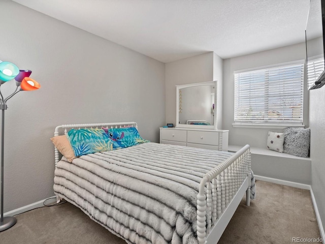 bedroom featuring carpet floors and a textured ceiling