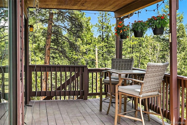 7221 S Brook Forest Rd, Evergreen, CO 80439 - deck featuring view of wooded area