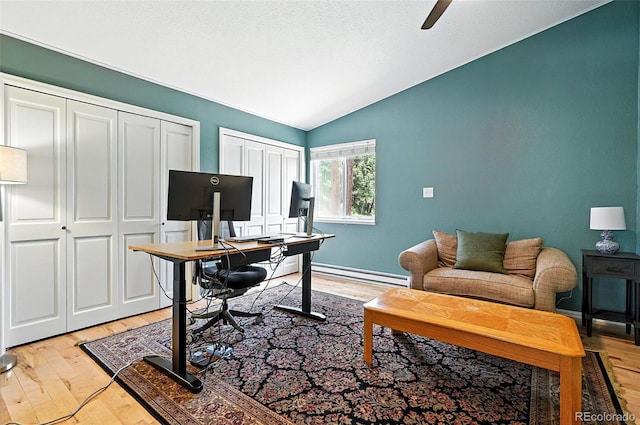 7221 S Brook Forest Rd, Evergreen, CO 80439 - office with baseboard heating, vaulted ceiling, light wood-style floors, and a ceiling fan