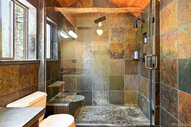 7221 S Brook Forest Rd, Evergreen, CO 80439 - full bath featuring a stall shower, vanity, tile walls, and lofted ceiling