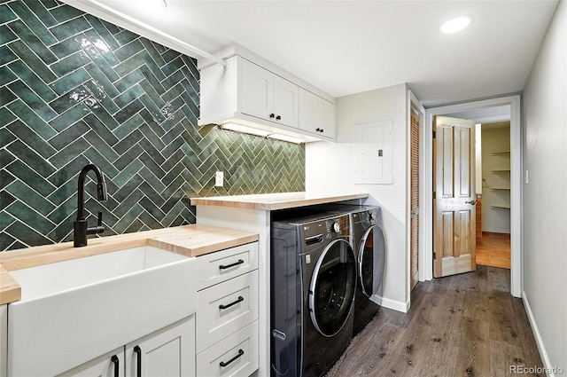 7221 S Brook Forest Rd, Evergreen, CO 80439 - laundry area featuring washer and dryer, cabinet space, electric panel, and dark wood-type flooring