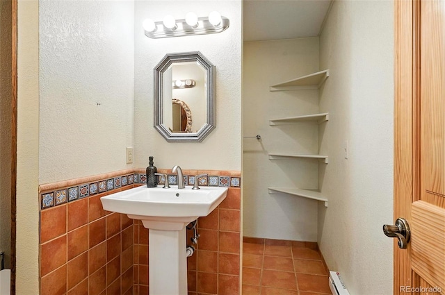 7221 S Brook Forest Rd, Evergreen, CO 80439 - bathroom featuring tile patterned flooring, tile walls, a wainscoted wall, and baseboard heating