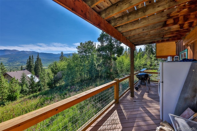 wooden terrace featuring a mountain view and grilling area