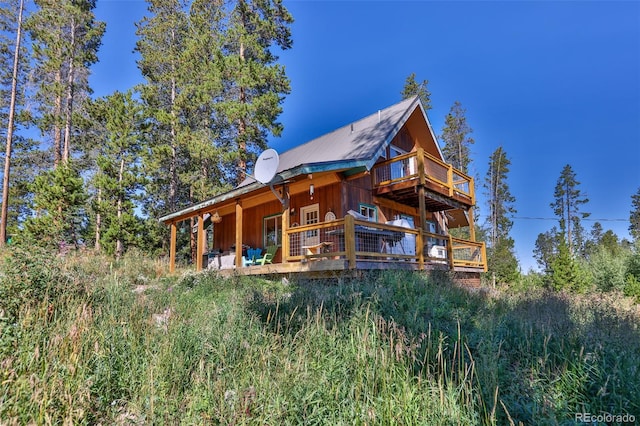 back of property with a wooden deck