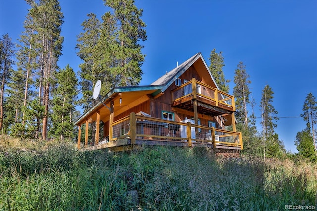 rear view of house with a wooden deck