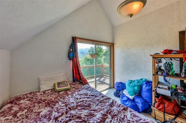 bedroom featuring vaulted ceiling and access to outside