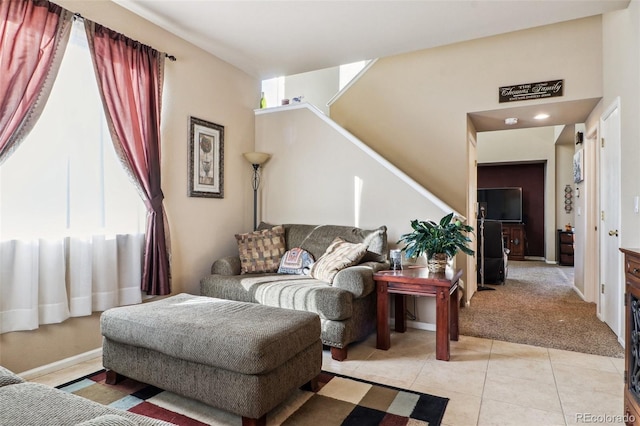 14389 E 101st Pl, Commerce City, CO 80022 - living room with stairs, light tile patterned flooring, and light carpet