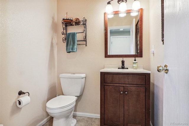 bathroom with tile patterned flooring, vanity, and toilet