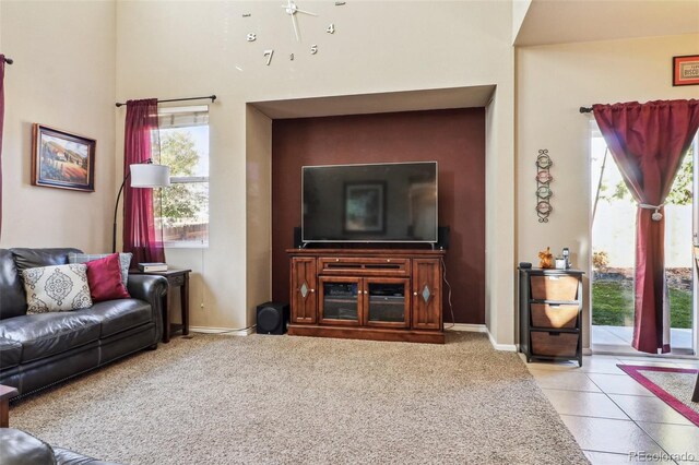 14389 E 101st Pl, Commerce City, CO 80022 - living room with baseboards, tile patterned flooring, a ceiling fan, and a high ceiling