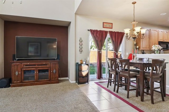 dining area with a notable chandelier and light tile patterned floors