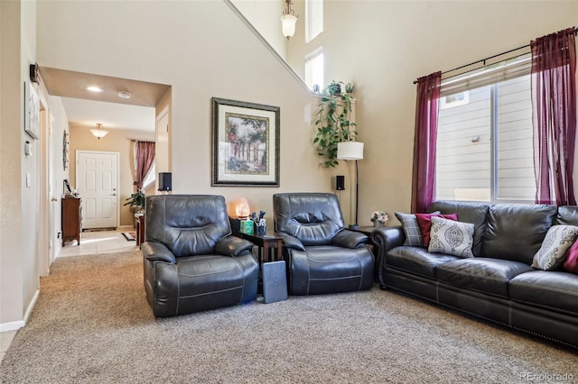 14389 E 101st Pl, Commerce City, CO 80022 - living room with carpet, healthy amount of natural light, a high ceiling, and baseboards