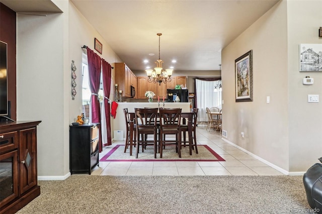 carpeted dining room with a notable chandelier and a wealth of natural light