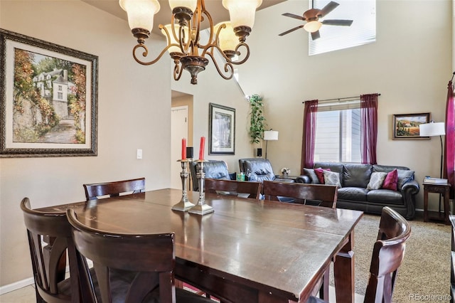 dining area with carpet flooring and ceiling fan with notable chandelier