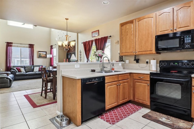 14389 E 101st Pl, Commerce City, CO 80022 - kitchen with black appliances, a sink, a chandelier, a peninsula, and open floor plan