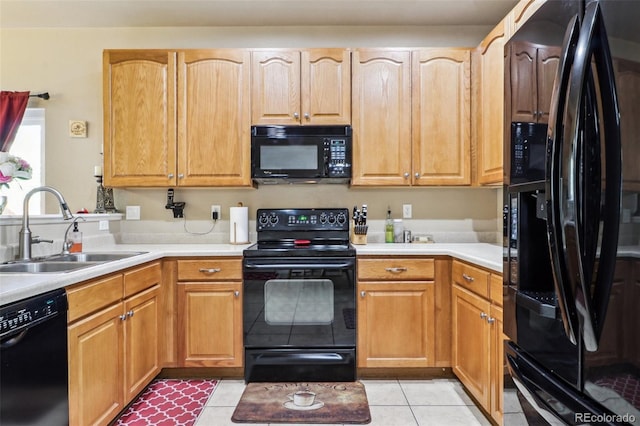 14389 E 101st Pl, Commerce City, CO 80022 - kitchen with black appliances, a sink, light countertops, and light tile patterned floors