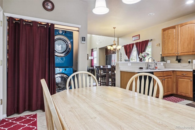 14389 E 101st Pl, Commerce City, CO 80022 - dining area with stacked washer / drying machine, a chandelier, light tile patterned flooring, and recessed lighting