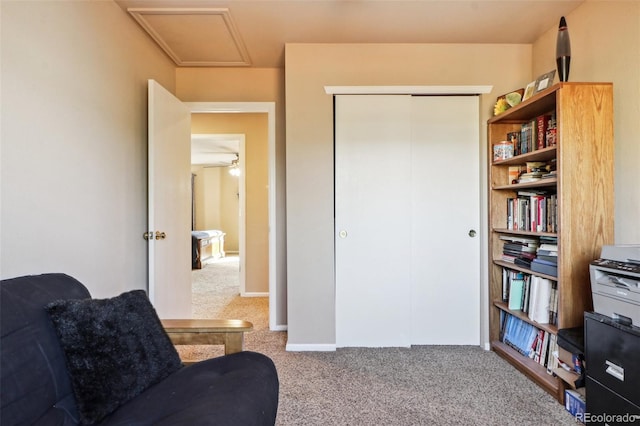 sitting room with carpet flooring and ceiling fan