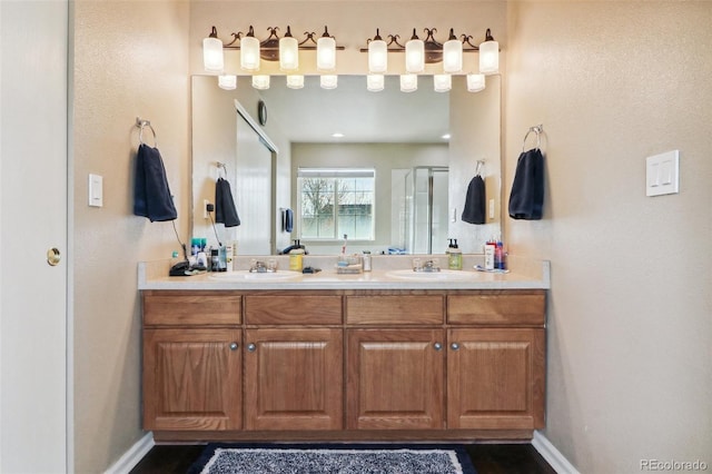14389 E 101st Pl, Commerce City, CO 80022 - full bathroom with double vanity, a shower stall, and baseboards