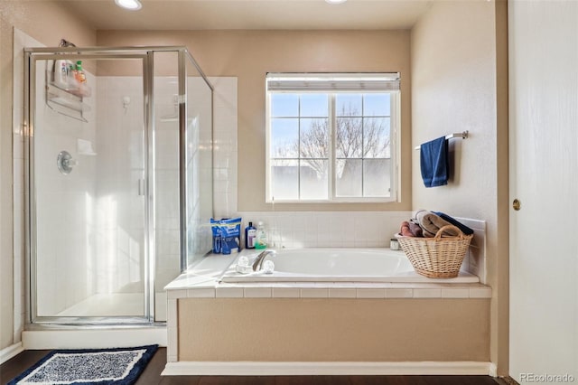 bathroom with separate shower and tub