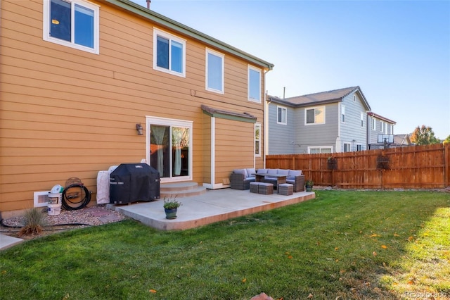 back of house featuring a lawn, an outdoor living space, and a patio