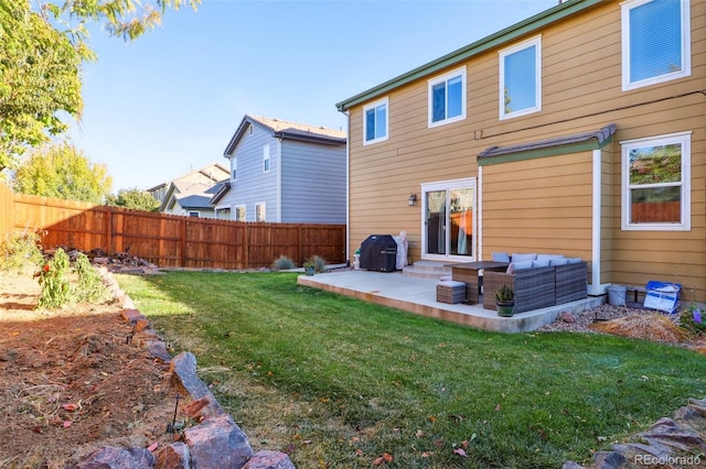 rear view of property featuring an outdoor living space, a yard, and a patio