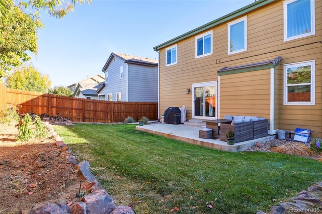 14389 E 101st Pl, Commerce City, CO 80022 - rear view of house with a patio and an outdoor living space