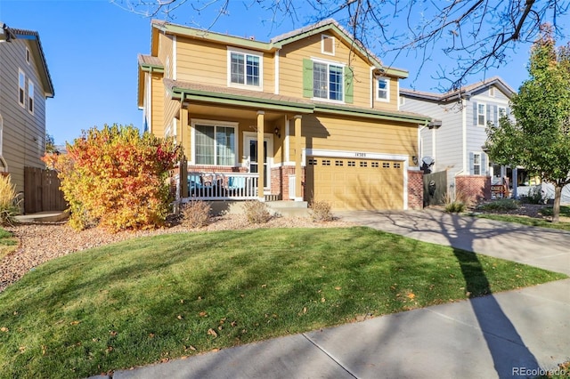 craftsman inspired home featuring covered porch, a garage, and a front lawn